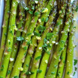 - 1 lb asparagus, trimmed - 3 tablespoons olive oil - 4 cloves garlic, minced - 1 teaspoon lemon zest - 2 tablespoons lemon juice - Sea salt and black pepper - 1/4 teaspoon red pepper flakes (optional) - Fresh parsley for garnish Lemon Garlic Roasted Asparagus is a simple and fresh dish. The main stars are the asparagus, olive oil, and garlic. These ingredients come together to create a bright flavor. Each ingredient plays a key role. The asparagus should be fresh and crisp. When you trim it, cut off the tough ends. This makes the dish more enjoyable. The olive oil adds richness, while the garlic gives a strong taste. I love using minced garlic for its bold flavor. Lemon adds that zesty kick. The zest and juice work together to brighten the dish. Sea salt and black pepper enhance all the flavors. You can adjust these to suit your taste. If you like a bit of heat, add red pepper flakes. They are optional but delicious. Fresh parsley is perfect for a colorful finish. It adds a nice touch to the plate. For the full recipe, check the details above. This dish is easy to make and a great addition to any meal. Enjoy the simple goodness! - Preheat the oven to 425°F (220°C). - Rinse the asparagus under cold water. - Trim the tough ends of the asparagus, about 1-2 inches. - Gather your other ingredients: olive oil, garlic, lemon zest, lemon juice, and spices. - In a large mixing bowl, combine 3 tablespoons of olive oil and 4 minced garlic cloves. - Add 1 teaspoon of lemon zest and 2 tablespoons of lemon juice. - Season the mixture with 1 teaspoon of sea salt, 1/2 teaspoon of black pepper, and 1/4 teaspoon of red pepper flakes, if you like some heat. - Stir everything well until it forms a smooth sauce. - Toss the trimmed asparagus in the lemon garlic sauce. - Make sure each piece is evenly coated. - Line a baking sheet with parchment paper. - Spread the asparagus in a single layer on the sheet. - Roast in the preheated oven for 12-15 minutes. - The asparagus should be tender and a bit crispy at the tips. This simple dish is bright, fresh, and full of flavor. If you want to see the complete recipe with measurements, check out the [Full Recipe]. How to choose fresh asparagus When picking asparagus, look for bright green spears. The tips should be tight and firm. Avoid any that look wilted or have a strong odor. Fresh asparagus should snap when you bend it. This ensures you get the best flavor and texture. Tips for roasting for the perfect texture Roasting asparagus at 425°F gives it a nice crispness. Spread the spears in a single layer on the baking sheet. This allows them to cook evenly. Overcrowding can cause steaming, making them soggy. Roast for 12-15 minutes, until they're tender at the base and slightly crispy at the tips. Adding cheese or nuts for extra richness For a creamy touch, sprinkle some grated Parmesan cheese on top before roasting. If you prefer crunch, toss in some chopped nuts like almonds or walnuts. These additions add great texture and depth to your dish. Using fresh vs. dried herbs Fresh herbs like parsley or thyme brighten the flavors of the asparagus. Dried herbs work well, too. If using dried herbs, use less since they are more potent. Fresh herbs give a nice pop and aroma that dried can’t match. Pairing with main dishes Lemon garlic roasted asparagus pairs well with many main dishes. Try it with grilled chicken, fish, or even a hearty steak. It adds a fresh element to any meal, balancing rich flavors. Creating a balanced meal Consider adding a grain like quinoa or rice to your plate. This adds fiber and makes the meal more filling. A simple salad on the side can also round out your meal nicely. For the full recipe, check the main article section. {{image_2}} You can change the flavor of this dish easily. Try swapping lemon for lime or orange. This small change brings a new taste that brightens the dish. You can also play with different herbs. Basil, thyme, or oregano works well with asparagus. Each herb adds its own touch, making it fun to try new options. Grilling asparagus offers a smoky flavor. Just heat your grill and cook the asparagus for a few minutes. This method gives you a nice char and a different taste. You can also steam the asparagus if you want a softer texture. Steaming keeps the bright green color and makes it tender. Making this dish vegan is simple. Just ensure your olive oil is pure, and skip any added cheese. You can also make it gluten-free, as all the ingredients are naturally gluten-free. For those watching sodium, use low-sodium salt or simply skip it. This way, you can enjoy the dish without worry. For the Full Recipe, check out the ingredients and steps to create this tasty dish. After you enjoy your Lemon Garlic Roasted Asparagus, store any leftovers in the refrigerator. Place them in an airtight container. This keeps them fresh and tasty for up to three days. If you want to keep the dish bright, cover the top with plastic wrap before sealing the lid. To reheat your asparagus, use the oven or a skillet. The oven helps keep it crisp. Preheat it to 350°F (175°C). Place the asparagus on a baking sheet and warm for about 10 minutes. If using a skillet, add a little olive oil, then heat over medium heat. Stir gently for a few minutes. This method helps maintain the flavor. Can you freeze roasted asparagus? Yes, you can freeze it! To do this, let the asparagus cool completely. Then, place it in a single layer on a baking sheet. Freeze for about an hour. Once frozen, transfer the asparagus to a freezer-safe bag. Remove as much air as possible. When you're ready to eat, just thaw it in the fridge overnight. You can also reheat it from frozen. Just add a few extra minutes to your cooking time. Enjoy your Lemon Garlic Roasted Asparagus later with all its great taste! For the full recipe, check out the details in the earlier sections. To make Lemon Garlic Roasted Asparagus perfectly, follow these steps: 1. Preheat your oven to 425°F (220°C). 2. Trim the asparagus ends to remove any tough parts. 3. Mix olive oil, minced garlic, lemon zest, lemon juice, sea salt, black pepper, and red pepper flakes in a bowl. 4. Coat the asparagus well with this mixture. 5. Spread the asparagus on a baking sheet in a single layer. 6. Roast for 12-15 minutes until tender and slightly crispy. This method ensures even cooking and great flavor. Trimming asparagus is simple. Hold the asparagus spear in both hands. Bend it gently until it snaps. This natural break point removes the tough part. You can also line up the spears and cut off about 1-2 inches from the bottom. Yes, you can use frozen asparagus. However, frozen asparagus has more water. This may change the texture after cooking. To use it, thaw and drain the asparagus first. Then, follow the same recipe. You may need to adjust cooking time. Lemon Garlic Roasted Asparagus pairs well with many dishes. Here are some ideas: - Grilled chicken or fish - Quinoa or rice - Pasta with a light sauce - A fresh salad These options balance the flavors and add variety to your meal. To adjust the spice level, you can: - Add more or less red pepper flakes. - Omit the red pepper flakes for no spice. - Use a pinch of cayenne pepper for more heat. These changes let you customize the dish to your taste. For the full recipe, check the earlier section. Lemon garlic roasted asparagus is simple and tasty. You learned about key ingredients and steps. Prepping asparagus, mixing the sauce, and roasting it brings out great flavors. Tips can help you enhance taste and texture. You can also try different herbs or cooking methods based on your needs. Remember to store and reheat leftovers properly to enjoy later. With these ideas, you can make a delicious dish every time. Enjoy your cooking adventure with lemon garlic roasted asparagus!