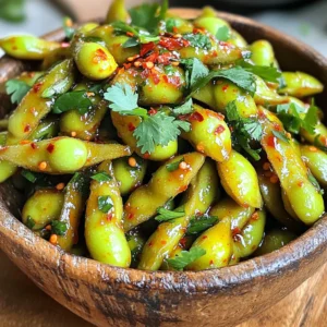 To make the Chili Garlic Edamame Snack, you need the following ingredients: - 2 cups frozen edamame (in pods) - 3 cloves garlic, minced - 2 tablespoons soy sauce - 1 tablespoon sesame oil - 1 teaspoon red pepper flakes (adjust to taste) - 1 tablespoon lime juice - 1 tablespoon fresh cilantro, chopped (for garnish) - Salt to taste When measuring ingredients, accuracy matters. Here’s how to measure: - Edamame: Use a measuring cup. Frozen edamame is often in bags. - Garlic: Mince the garlic cloves finely. Use a knife or a garlic press. - Soy Sauce & Sesame Oil: Use tablespoons for liquid ingredients. Pour carefully. - Red Pepper Flakes: Start with a teaspoon. You can add more later if needed. - Lime Juice: Fresh lime gives the best flavor. Squeeze it and measure. - Cilantro: Chop finely for garnish. A little goes a long way! - Salt: Add to taste. Start with a pinch and adjust as needed. You may wonder if fresh or frozen edamame is better. Here’s what I think: - Frozen Edamame: This is what I use. It’s easy and ready to cook. You can find it in most grocery stores. It is quick to prepare, and it keeps well. - Fresh Edamame: If you find fresh edamame, it can taste sweeter. You will need to cook it longer. Look for bright green pods without blemishes. Using frozen edamame is simple and saves time. Choose what you like best! Start by boiling a pot of water. Use enough water to cover the edamame. Once the water boils, add 2 cups of frozen edamame pods. Cook them for about 4 to 5 minutes. You want them tender but still firm. Drain the edamame and place them in a large mixing bowl. Now, let’s make the sauce. Heat a small skillet over medium heat. Add 1 tablespoon of sesame oil to the skillet. Once the oil is hot, toss in 3 minced garlic cloves. Sauté the garlic for 1 to 2 minutes. Watch closely; you don’t want it to brown. Next, add 2 tablespoons of soy sauce, 1 teaspoon of red pepper flakes, and 1 tablespoon of lime juice. Stir well and cook for another minute. Pour the chili garlic sauce over the cooked edamame. Toss everything together until the edamame are well-coated. Taste and add salt if needed. Finally, transfer the edamame to a serving bowl. Finish with a sprinkle of fresh chopped cilantro. Enjoy your spicy snack! To get the best texture, boil the edamame for 4-5 minutes. Make sure the water is at a rolling boil. This helps the pods cook evenly. After boiling, drain them well. If you leave water, they can become soggy. For extra flavor, you can steam the edamame instead of boiling. Steaming keeps them bright green and tender. It also locks in their natural taste. If you love heat, add more red pepper flakes. Start with the one teaspoon in the recipe. Taste the mixture before adding more. You can also use fresh chili for a different kick. If you prefer less spice, cut back on the flakes. Another option is to add a touch of honey. It balances the heat and adds sweetness. If you want a gluten-free option, try tamari. It has a similar taste and works well in this recipe. Coconut aminos are another great choice. They are slightly sweeter but still add umami. For a soy-free option, use liquid aminos. They give a nice flavor without soy. You can also skip the soy sauce entirely and use more lime juice for zest. {{image_2}} You can change the flavors of your chili garlic edamame easily. For a sweeter touch, add honey or maple syrup. Try swapping lime juice with lemon juice for a different zing. You might also use tamari instead of soy sauce for a deeper flavor. If you enjoy Asian spices, add five-spice powder. This adds warmth and richness. For a Mediterranean flair, sprinkle in some smoked paprika. These tweaks make each bite exciting. Want to make this snack heartier? Add protein! Try tossing in cooked shrimp or grilled chicken. Both pair well with the spicy garlic blend. If you prefer plant-based proteins, add tofu cubes. You can pan-fry or bake the tofu for a crispy texture. Also, consider adding chickpeas for a hearty option. They soak up flavors well, giving you a tasty and filling snack. Keeping it vegan? Great choice! The recipe is already vegan-friendly. Just ensure you use gluten-free soy sauce or tamari. This way, you keep all the flavor without gluten. If you want extra crunch, add roasted nuts like peanuts or cashews. They add a nice bite and work well with the spice. You can also serve the edamame in lettuce wraps for a fun twist. Enjoy exploring these variations to make the snack your own! After enjoying your spicy chili garlic edamame, store any leftovers in an airtight container. Place them in the fridge. They stay fresh for up to three days. Make sure to let them cool before sealing. This helps keep them crunchy. If you want to save some for later, freezing is a great option. Spread the edamame in a single layer on a baking sheet. Freeze them for about one hour. Once frozen, transfer them to a freezer bag. They can last for up to three months. This way, you can enjoy the snack anytime! To reheat, take the frozen edamame and boil them in water for about 3-4 minutes. If they are in the fridge, you can sauté them in a pan. Add a little sesame oil for extra flavor. Heat them just until warm. This keeps the spice and taste just right! Yes, you can use fresh edamame. Fresh edamame cooks faster than frozen. You will need to boil fresh edamame for about 3-4 minutes. This small change keeps the flavor bright and fresh. Just make sure to check for tenderness. To add more heat, increase the red pepper flakes. You can also add fresh chopped chili peppers. Try using a dash of hot sauce for a different kick. Adjust the spice to fit your taste. Start small, then add more as you go. This way, you can find your perfect heat level. You can find chili garlic edamame snacks at many grocery stores. Look in the frozen food section. Some health food stores also carry them. If you want convenience, check online retailers. They often have a wide range of products. You learned about ingredients, preparation, and tasty variations for chili garlic edamame. We discussed fresh versus frozen, spice adjustments, and easy storage tips. I encourage you to try different flavors and protein options to make this snack your own. Remember, simple tweaks can enhance your dish greatly. Enjoy experimenting with your edamame. It’s a great way to enjoy healthy snacks!