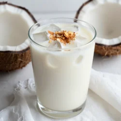 To make creamy coconut horchata, you need these simple ingredients: - 1 cup long-grain white rice - 4 cups water - 1 cup coconut milk - 1/2 cup sweetened condensed milk - 1 teaspoon vanilla extract - 1/2 teaspoon ground cinnamon - Ice cubes, for serving - Toasted coconut flakes, for garnish You can add these optional ingredients to make your horchata unique: - A pinch of sea salt for balance - A splash of coconut extract for extra coconut flavor - A dash of nutmeg for warmth Accurate measuring helps create the best flavor. Here are some tips: - Use a dry measuring cup for the rice. - For liquids, use a liquid measuring cup. - When measuring condensed milk, use a sticky spatula to scrape it out. - Level off dry ingredients with a straight edge for precision. These tips ensure your creamy coconut horchata shines. Enjoy making this refreshing drink! {{ingredient_image_1}} First, rinse the rice under cold water. This step is key. You want the water to run clear. Rinsing helps remove extra starch. This keeps your drink smooth. Use a fine mesh sieve or bowl for this. It takes just a few minutes. Next, place the rinsed rice in a blender. Add 2 cups of water to the blender. Blend on high for about 1 to 2 minutes. You want the rice to be finely ground. This step helps release the rice's flavor. Make sure there are no large pieces left. Now, strain the rice mixture into a large pitcher. Use a fine mesh sieve or cheesecloth. Discard the solid rice left in the sieve. Add the remaining 2 cups of water, coconut milk, sweetened condensed milk, vanilla extract, and ground cinnamon to the pitcher. Stir everything well. It should blend nicely. Taste your horchata and adjust the sweetness if needed. Add more condensed milk for extra sweetness. Refrigerate for at least 2 hours. This chill time makes a big difference. Serve over ice cubes in tall glasses. Top with toasted coconut flakes for a lovely look. Enjoy your creamy coconut horchata! To make your horchata just right, start with the sweetened condensed milk. This adds a rich, sweet flavor. If you want it sweeter, add more condensed milk. You can also sprinkle in extra cinnamon. This will enhance the taste and aroma. Taste it as you mix. This way, you can find your favorite level of sweetness and spice. Chilling your horchata is key for a refreshing drink. After mixing, place it in the fridge for at least two hours. This allows the flavors to blend. For quicker chilling, pour it into smaller containers. They cool down faster. Serve it over ice to keep it cold longer. Always use fresh ice cubes for the best taste. Serve your horchata in tall glasses. This makes it look fancy. Top each glass with toasted coconut flakes. This adds a crunchy texture. If you want a visual pop, add a sprinkle of cinnamon on top. You can also add a slice of lime for a zesty twist. Enjoy this drink with friends or family on a hot day. It&rsquo;s perfect for summer! Pro Tips Rinsing the Rice: Rinse the rice thoroughly to eliminate excess starch, which can make the horchata too thick. Blending Technique: Blend the rice and water until finely ground, ensuring a smooth and creamy texture for your horchata. Chill Time: Allow the horchata to chill for at least 2 hours; this helps the flavors meld beautifully and enhances the taste. Garnishing: For added flavor and presentation, garnish with toasted coconut flakes just before serving. {{image_2}} You can easily make this drink dairy-free. Just swap out the sweetened condensed milk. Use coconut cream or a dairy-free sweetener instead. Almond milk is another good choice. It adds a nutty flavor. This keeps the drink light and tasty. Want to mix it up? Add different flavors! Chocolate is a fun twist. Just blend in cocoa powder with the rice. Almond flavor is also nice. Use almond extract instead of vanilla. Both options give your horchata a new vibe. Cold brew coffee lovers will enjoy this! Start by making cold brew coffee. Use a strong blend for rich flavor. Then, mix the cold brew with your coconut horchata. This gives you a refreshing boost. Serve it over ice for a perfect summer drink. To keep your creamy coconut horchata fresh, store it in a glass pitcher. Make sure the pitcher is tightly sealed. This prevents any strange smells from getting in. Always keep it in the fridge. The cold helps maintain its flavor and texture. If stored properly, your horchata lasts about three to five days. The flavors will deepen as it sits. However, it&rsquo;s best enjoyed fresh. If you notice any changes in smell or texture, it&rsquo;s time to toss it out. You can use leftover horchata in many fun ways. Try it as a base for smoothies. Blend it with fruits like bananas or berries for a tasty drink. You can also use it in baking. It adds moisture to cakes or pancakes. Get creative and enjoy every drop! Horchata is a sweet, creamy drink made from rice. It has roots in Mexico and Spain. The drink usually includes water, sugar, and spices. In this recipe, we add coconut milk and sweetened condensed milk for rich flavor. The result is a refreshing drink perfect for summer. Yes, you can use different types of milk. Almond milk or oat milk works well. For a richer taste, try using whole milk. Each milk gives a unique flavor to the drink. Just keep in mind that the texture and taste may change slightly. You can make horchata without a blender by soaking rice. Start by rinsing the rice well. Then, soak it in water for at least 4 hours. After soaking, mash the rice with a spoon or your hands. Strain the rice like before, then mix in the other ingredients. This method takes a bit longer but works just fine. This post shared how to make delicious horchata. We covered key ingredients and optional add-ins. I provided tips for measuring and preparing rice. You learned how to blend, strain, and mix the drink well. We also explored ways to adjust sweetness and served it right. Remember, you can customize your horchata in many ways. Use dairy-free milk or infuse flavors. Proper storage helps your drink last longer and stay fresh. Try different methods, and enjoy your unique creations!