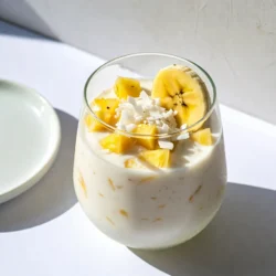 I use 1 cup of fresh pineapple chunks. This gives the smoothie a bright, sweet taste. Pineapple also adds a nice tropical flair. When cutting, choose ripe fruit for the best flavor. I like to add 1 cup of coconut milk. You can also use unsweetened coconut yogurt. Both options give a creamy texture and rich flavor. They add healthy fats, making the drink filling and satisfying. One frozen banana is key. It adds natural sweetness and creaminess. Frozen bananas help the smoothie feel cold and thick. I always keep some in my freezer for recipes like this. You might want to sweeten your smoothie. I suggest 1 tablespoon of honey or agave syrup. This step is optional. Adjust the sweetness based on your taste. I add 2 tablespoons of unsweetened shredded coconut. It gives a nice texture and extra coconut flavor. You can sprinkle some on top for a fun garnish. For a hint of warmth, I use 1/2 teaspoon of vanilla extract. It enhances the flavors. Vanilla makes the smoothie feel more indulgent without added calories. If you like your smoothie colder, add a handful of ice cubes. This step is optional but helps with thickness. You can also top it with more shredded coconut or fresh fruit for a beautiful finish. {{ingredient_image_1}} First, gather all your ingredients. You need: - 1 cup fresh pineapple chunks - 1 cup coconut milk (or unsweetened coconut yogurt) - 1 frozen banana - 1 tablespoon honey or agave syrup (optional) - 2 tablespoons shredded coconut (unsweetened) - 1/2 teaspoon vanilla extract - Ice cubes (optional) Next, wash the pineapple and chop it into chunks. Make sure to use fresh pineapple for the best taste. If you don&rsquo;t have fresh pineapple, frozen works too. Now, add the pineapple chunks to your blender. Pour in the coconut milk next. Then, add the frozen banana. The banana makes the smoothie creamy. If you're using honey or agave, add it now. Sprinkle in the shredded coconut and vanilla extract. Blend everything on high speed until it&rsquo;s smooth. You want a creamy texture, so check that no lumps remain. After blending, taste the smoothie. If it&rsquo;s not sweet enough, add more honey or agave syrup. Blend again for a few seconds. If you want it colder, add ice cubes and blend until smooth. This will make the drink thicker and chill it down. Pour the smoothie into glasses. For a nice touch, sprinkle some shredded coconut on top. This adds texture and makes it look pretty. Enjoy your refreshing tropical drink right away! Pick a ripe pineapple for the best taste. Look for a fruit with a sweet smell. The leaves should be green and fresh. A good pineapple has a firm feel but gives slightly when pressed. If you find a yellow color near the base, that's a sign of ripeness. You can adjust the sweetness of your smoothie easily. If you like sweeter drinks, add more honey or agave syrup. Start with one tablespoon and taste it. For thickness, use frozen bananas or add ice cubes. Blend until you reach your favorite consistency. Remember, a thicker smoothie feels more satisfying! A good blender makes all the difference. Use a high-speed blender for the best results. It will blend your pineapple and coconut smoothly. If you have a regular blender, blend in stages. Start with liquids, then add fruits. This helps mix everything well. Clean your blender right after use for easy cleanup! Pro Tips Choose Ripe Pineapple: For the sweetest flavor, select a ripe pineapple with a sweet aroma and slightly soft feel at the base. Frozen Banana Benefits: Using a frozen banana not only chills the smoothie but also adds creaminess without the need for ice. Adjust Sweetness: Taste your smoothie before serving and adjust the sweetness by adding honey or agave syrup to suit your preference. Garnish for Texture: Top your smoothie with extra shredded coconut or a slice of pineapple for added texture and visual appeal. {{image_2}} Pineapple is a juicy, sweet fruit packed with nutrients. It has vitamin C, which helps our immune system. This fruit also has fiber, aiding digestion. Pineapple contains bromelain, a natural enzyme that can reduce inflammation. Eating pineapple may help with recovery after exercise, too. Coconut brings healthy fats to your smoothie. These fats can provide energy and support brain health. Coconut milk or yogurt is rich in vitamins and minerals. It also adds a creamy texture to our drink. Unsweetened shredded coconut is high in fiber, promoting good digestion. This coconut pineapple smoothie is a real treat for your body. Together, pineapple and coconut boost your energy and mood. The mix of flavors delights your taste buds while offering key nutrients. Enjoying this smoothie can support hydration and keep you feeling fresh. It&rsquo;s a great way to start your day or recharge after a workout! You can easily add greens to your coconut pineapple smoothie. Spinach or kale works great. These greens boost nutrients without changing the flavor much. Just a handful of fresh spinach or a small amount of kale will do. Blend it in with your other ingredients. You won't even notice it&rsquo;s there! If you want more protein, try adding protein powder or yogurt. A scoop of protein powder can make it filling. Use your favorite flavor, like vanilla or unflavored. Greek yogurt also adds creaminess and protein. This change makes the smoothie a great post-workout drink. You can mix in other tropical fruits like mango or papaya. These fruits add new flavors and textures. Swap out some pineapple or add them alongside it. They pair well with coconut and keep the smoothie fresh and bright. Plus, they increase the health benefits, making your drink even better! Yes, you can use frozen pineapple. It makes the smoothie cold and thick. Just blend it the same way as fresh. Frozen pineapple still gives great flavor. It is also convenient to use. You can use almond milk or soy milk. Unsweetened coconut yogurt works well, too. These options keep the smoothie creamy. They also add different flavors that are tasty. To make it vegan, skip honey and use agave syrup. Make sure to use plant-based yogurt or milk. All other ingredients are already vegan-friendly. This way, everyone can enjoy the smoothie! The smoothie lasts about one day in the fridge. It tastes best fresh, but you can store it. Just put it in a sealed container. Shake it well before drinking. Yes, you can meal prep this smoothie. Mix all the ingredients but skip the liquid. Freeze the mix in bags. When ready to drink, blend with coconut milk. This makes a quick and easy treat! This blog post covers a delightful smoothie recipe that&rsquo;s easy to make. We looked at all the vital ingredients like fresh pineapple and coconut milk. You learned how to blend and serve your smoothie with tips for custom flavors. Overall, this smoothie not only tastes great but also packs health benefits. Feel free to experiment with toppings and variations to make it your own. Enjoy mixing, blending, and sipping!